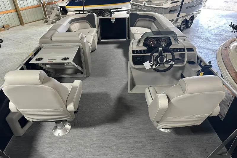 Slide: The Image of 2026 Godfrey SW 2286 SFL pontoon boat interior with plush seating and modern dashboard. - 11
