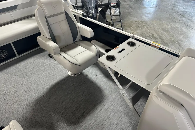 Slide: The Image of 2026 Godfrey SW 2286 SFL boat interior with swivel chair and foldable table. - 13
