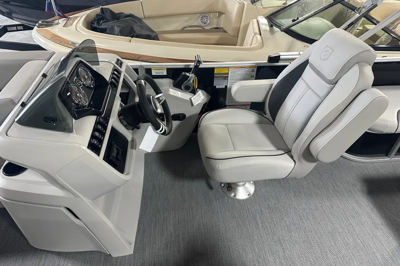 Slide: The Image of 2026 Godfrey SW 2286 SFL boat interior with steering console and captain's chair. - 14