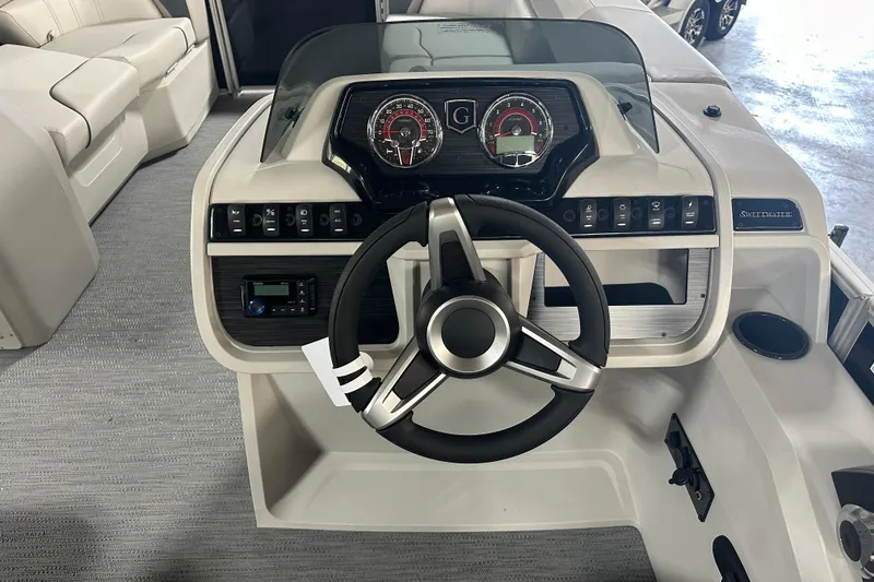 Slide: The Image of 2026 Godfrey SW 2286 SFL boat dashboard with steering wheel and control panel. - 16