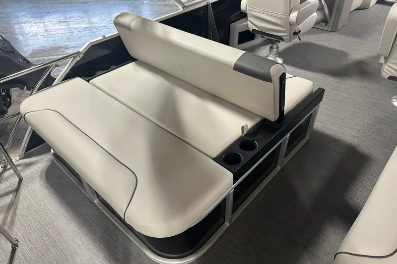 Slide: The Image of 2026 Godfrey SW 2286 SFL boat interior with beige seating and cup holders. - 7