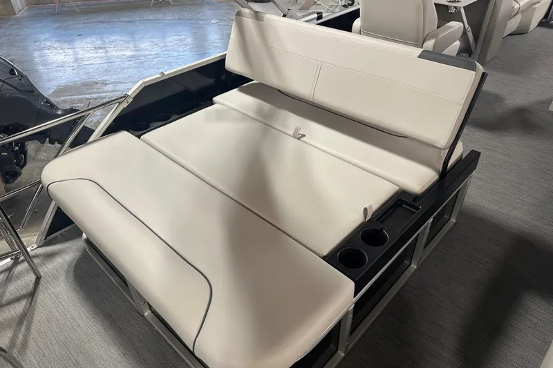 Slide: The Image of 2026 Godfrey SW 2286 SFL boat interior with beige seating and cup holders. - 8