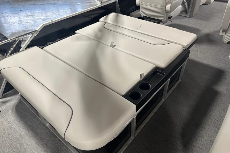 Slide: The Image of 2026 Godfrey SW 2286 SFL boat interior with beige seating and cup holders. - 9