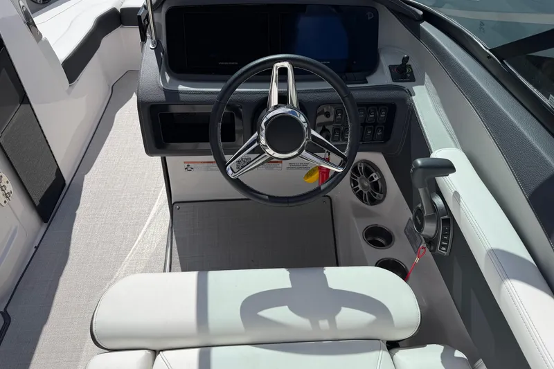 Slide: The Image of 2025 Regal LS6 boat cockpit with modern steering wheel and control panel. - 13