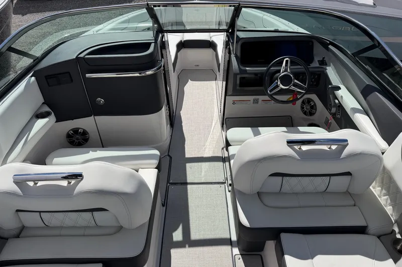 Slide: The Image of 2025 Regal LS6 boat interior with modern steering, plush seating, and sleek design. - 14