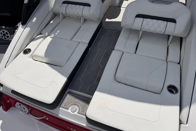 Slide: The Image of Luxurious 2025 Regal LS6 boat interior with white leather seating and cup holders. - 18