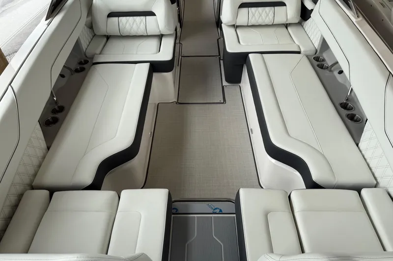 Slide: The Image of Luxurious interior of 2025 Regal LS6 boat with white leather seating and cup holders. - 2