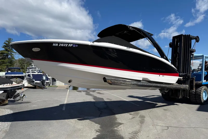 Slide: The Image of 2025 Regal LS6 boat lifted by forklift on sunny day at marina. - 22