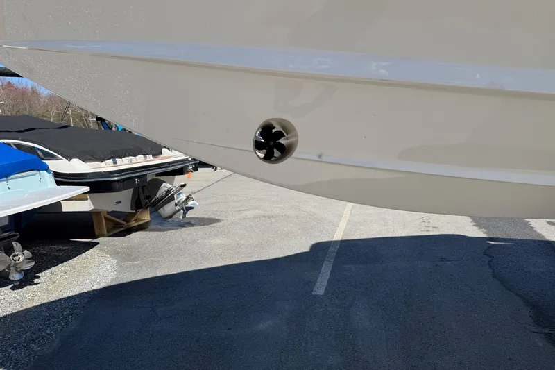 Slide: The Image of 2025 Regal LS6 boat hull with visible thruster, parked outdoors. - 23