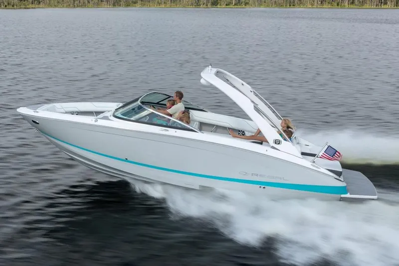 Slide: The Image of Manufacturer Provided Image: 2025 Regal LS6 boat cruising on a lake with passengers enjoying the ride. - 8
