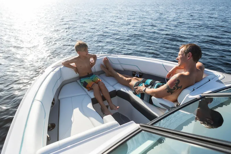 Slide: The Image of Manufacturer Provided Image: Father and son relaxing on a 2025 Regal LS6 boat in sunny weather. - 9