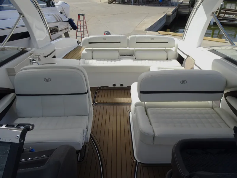 Slide: The Image of 2018 Cobalt R30 boat interior with white leather seating and wooden flooring. - 12
