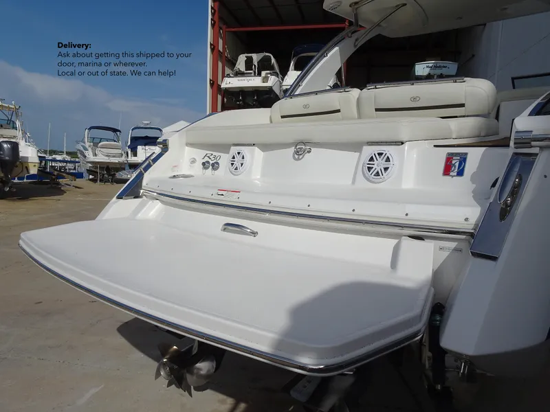 Slide: The Image of 2018 Cobalt R30 boat with extended swim platform in a marina. - 14