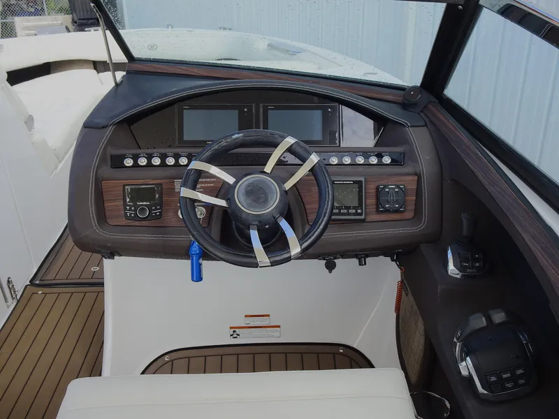 Slide: The Image of 2018 Cobalt R30 boat dashboard with steering wheel and control panel. - 16