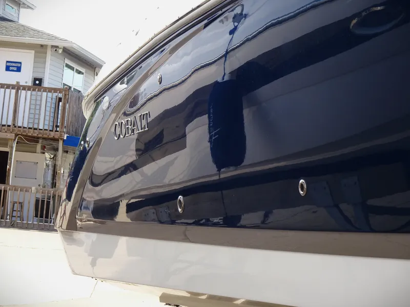 Slide: The Image of 2018 Cobalt R30 boat docked near a building. - 5