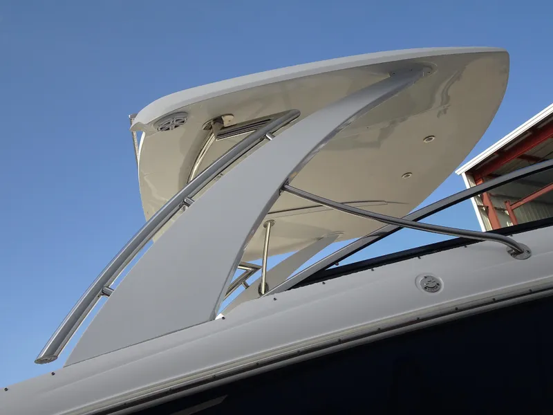 Slide: The Image of 2018 Cobalt R30 boat with sleek white arch and hardtop against blue sky. - 8