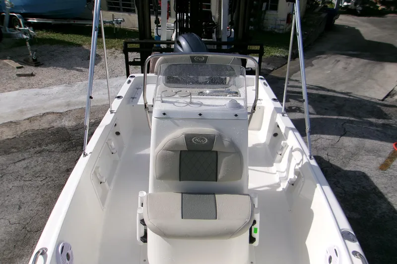 Slide: The Image of 2026 Key West 1720 Center Console boat interior, featuring seating and steering console. - 11