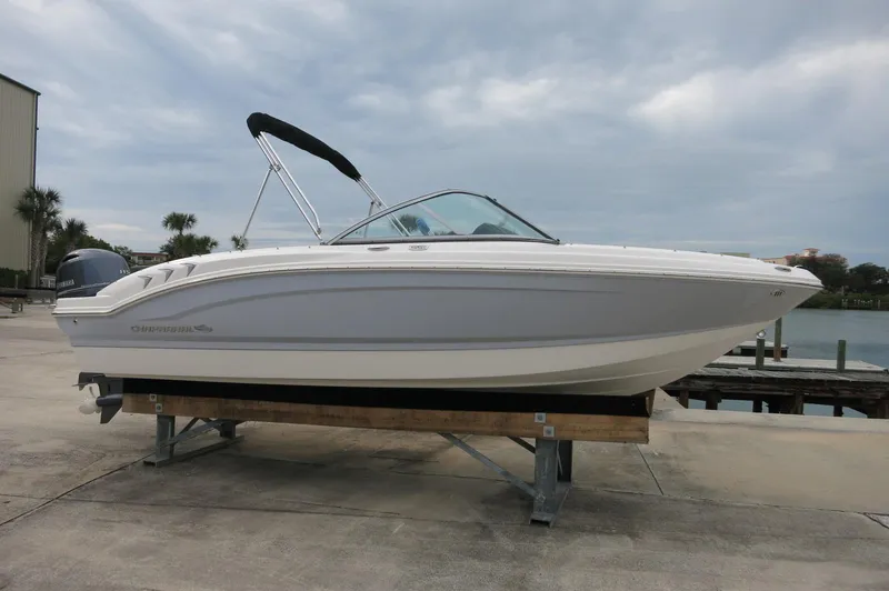The Image of 2024 Chaparral 19 SSi boat on a dock with a cloudy sky background. - 1