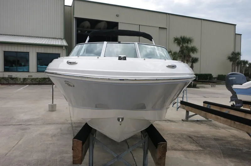 Slide: The Image of 2024 Chaparral 19 SSi boat on display outside a warehouse. - 10