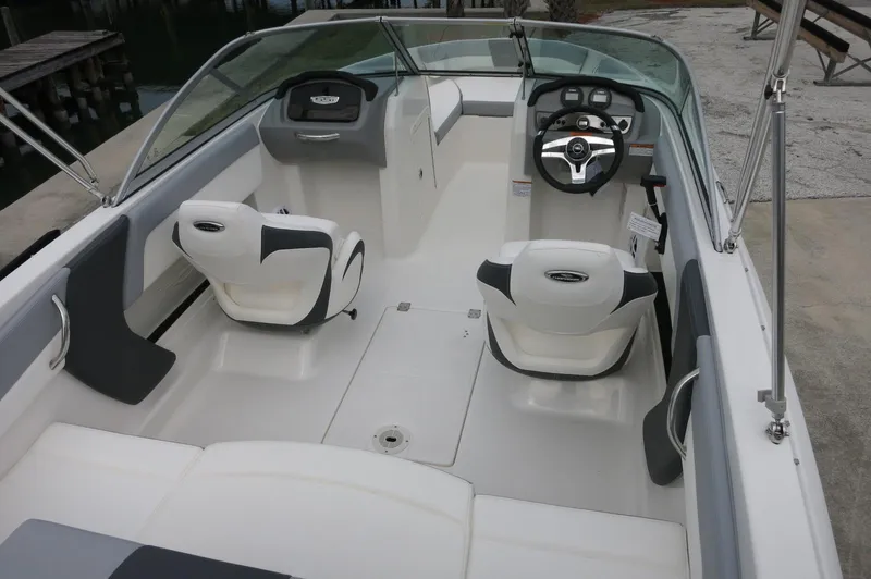 Slide: The Image of 2024 Chaparral 19 SSi boat interior with seating and steering console. - 14