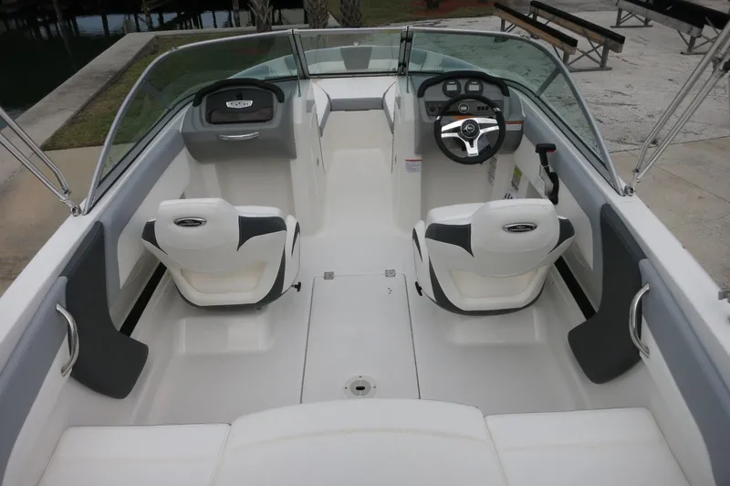 Slide: The Image of 2024 Chaparral 19 SSi boat interior with white and gray seating. - 15