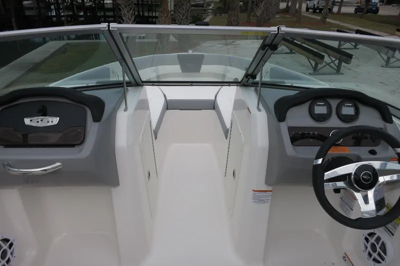 Slide: The Image of 2024 Chaparral 19 SSi boat interior with dual consoles and steering wheel. - 16