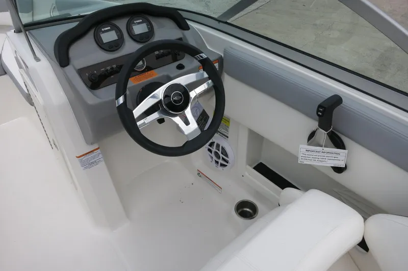 Slide: The Image of 2024 Chaparral 19 SSi boat cockpit with steering wheel and dashboard. - 23
