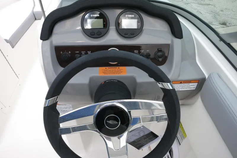 Slide: The Image of 2024 Chaparral 19 SSi boat dashboard with steering wheel and Yamaha gauges. - 25