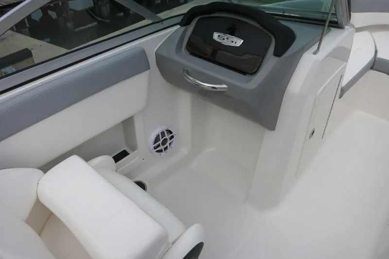 Slide: The Image of 2024 Chaparral 19 SSi boat interior with white seating and dashboard. - 26
