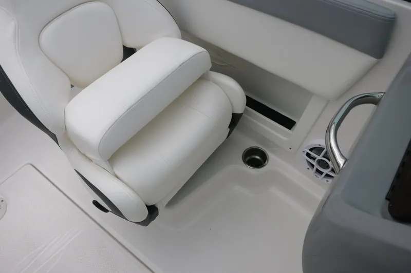 Slide: The Image of 2024 Chaparral 19 SSi boat interior with white seating and cup holder. - 28