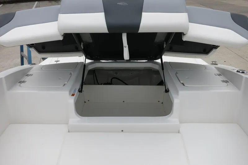 Slide: The Image of 2024 Chaparral 19 SSi boat with open storage compartment and seating area. - 32