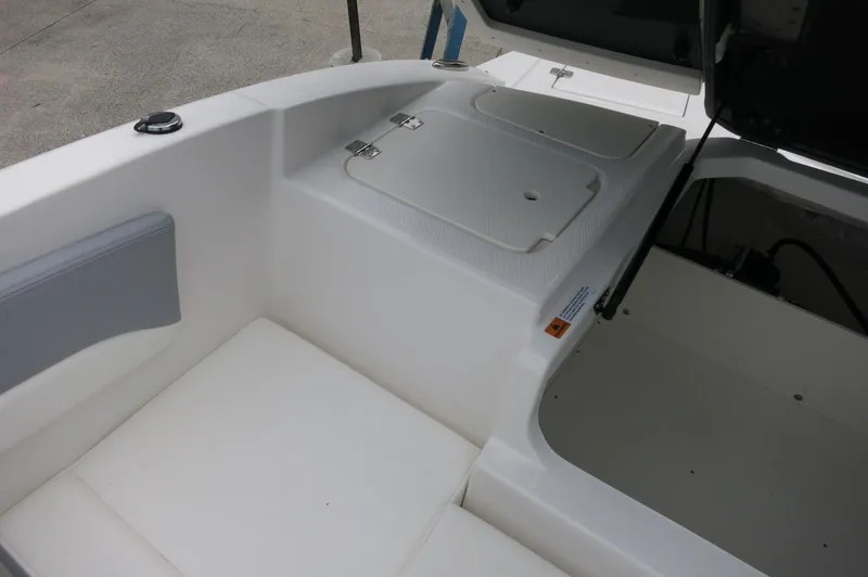 Slide: The Image of 2024 Chaparral 19 SSi boat interior storage compartments and seating area. - 34