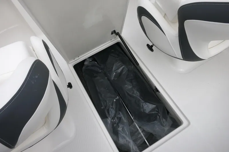 Slide: The Image of 2024 Chaparral 19 SSi boat interior storage compartment between seats. - 35