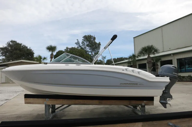 Slide: The Image of 2024 Chaparral 19 SSi boat on display outside a warehouse. - 8