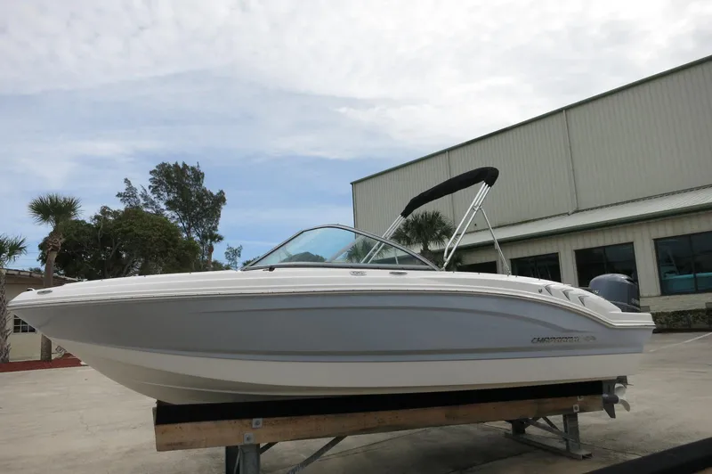 Slide: The Image of 2024 Chaparral 19 SSi boat on display outside a warehouse. - 9