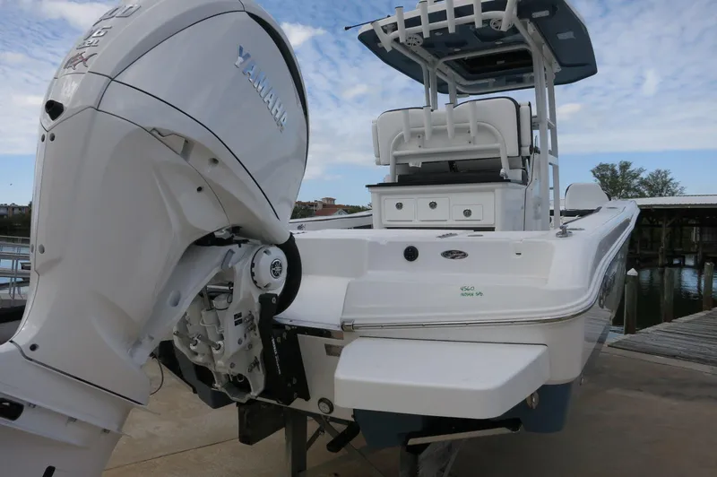 Slide: The Image of 2024 Crevalle 26 HCO boat with Yamaha outboard motor, docked by the water. - 11