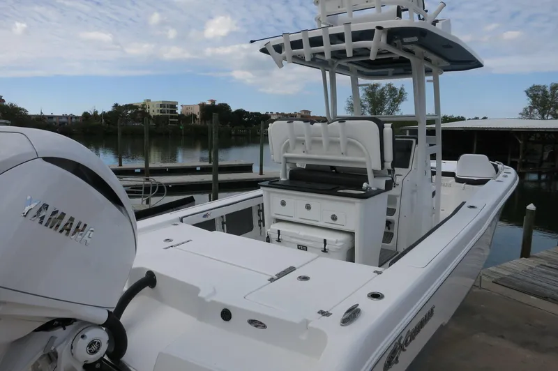 Slide: The Image of 2024 Crevalle 26 HCO boat docked, featuring Yamaha outboard motor. - 13