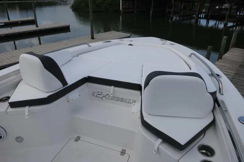Slide: The Image of 2024 Crevalle 26 HCO boat with white and black seating at the bow. - 15