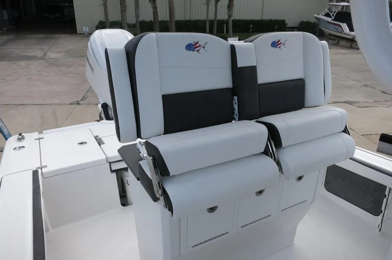 Slide: The Image of 2024 Crevalle 26 HCO boat with dual white and black cushioned seats. - 16