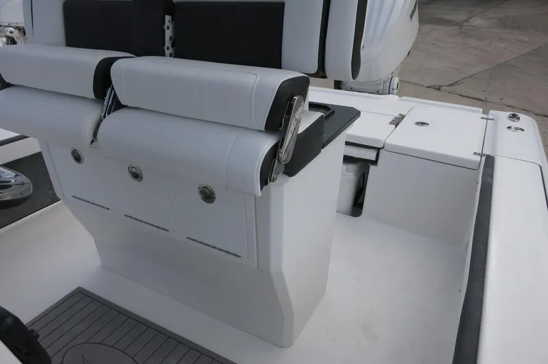 Slide: The Image of 2024 Crevalle 26 HCO boat interior with cushioned seating and storage compartments. - 23