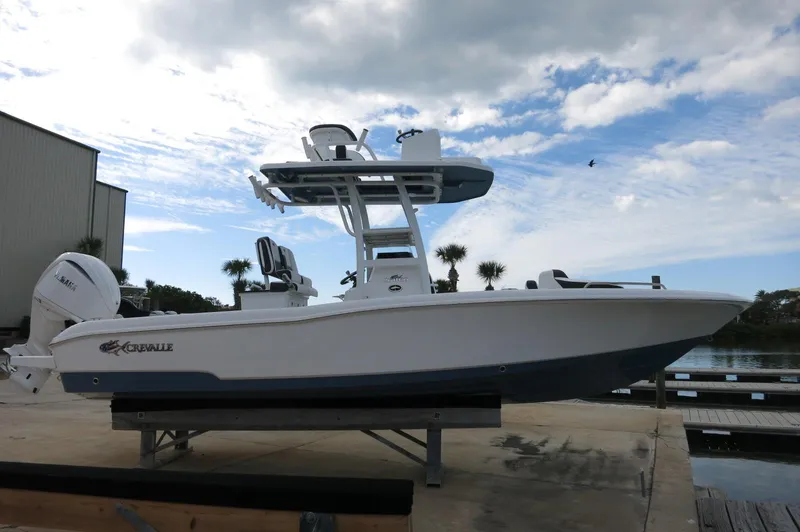 Slide: The Image of 2024 Crevalle 26 HCO boat on a dock with a clear sky background. - 3