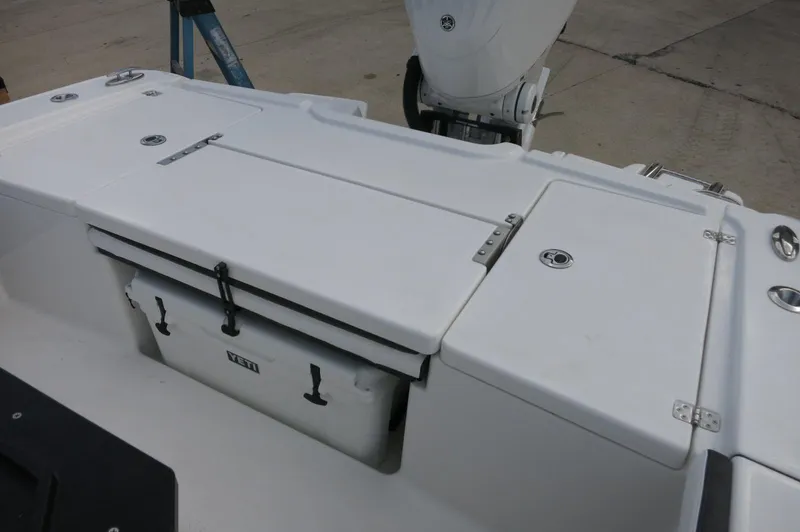 Slide: The Image of 2024 Crevalle 26 HCO boat deck with storage compartments and cooler. - 30