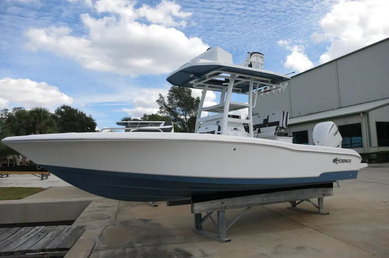Slide: The Image of 2024 Crevalle 26 HCO boat on display at a marina. - 7