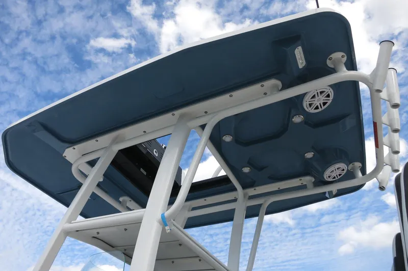 Slide: The Image of 2024 Crevalle 26 HCO boat T-top against a blue sky. - 8