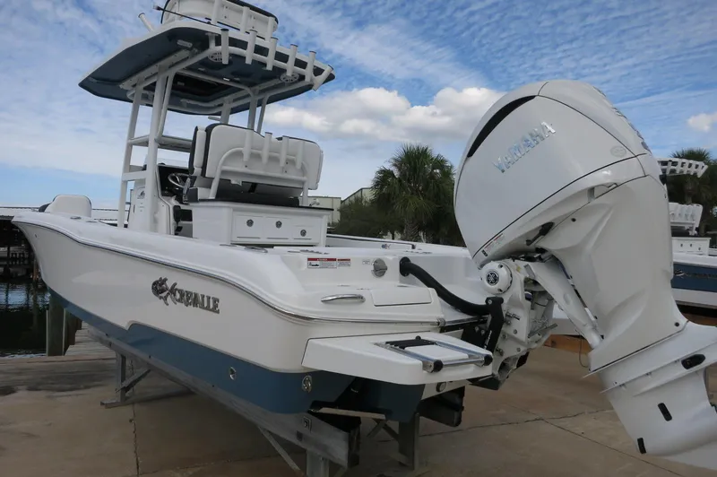 Slide: The Image of 2024 Crevalle 26 HCO boat with outboard motor on a dock. - 9