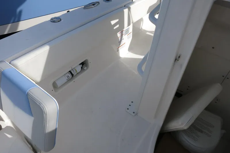 Slide: The Image of 2024 Robalo R266 Skydeck boat interior, featuring seating and storage compartments. - 12