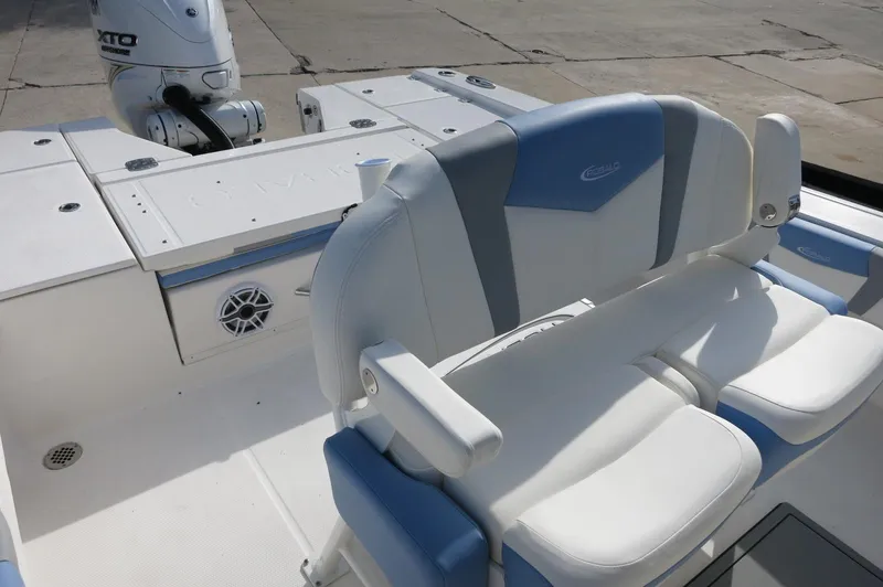 Slide: The Image of 2024 Robalo R266 Skydeck boat with white and blue seating and Yamaha outboard motor. - 14