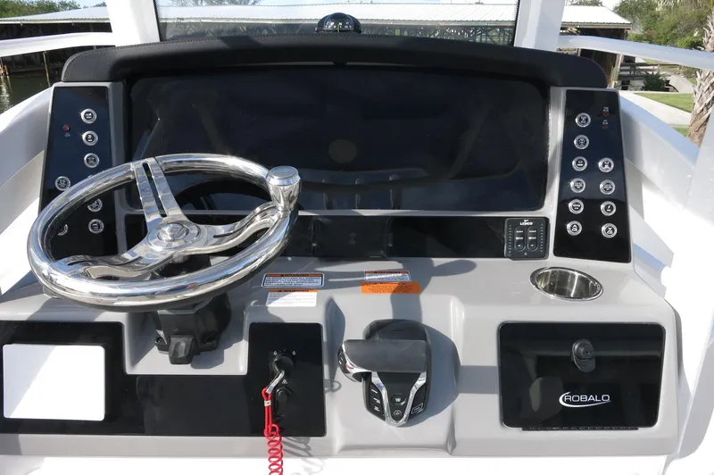 Slide: The Image of 2024 Robalo R266 Skydeck helm with modern controls and steering wheel. - 15