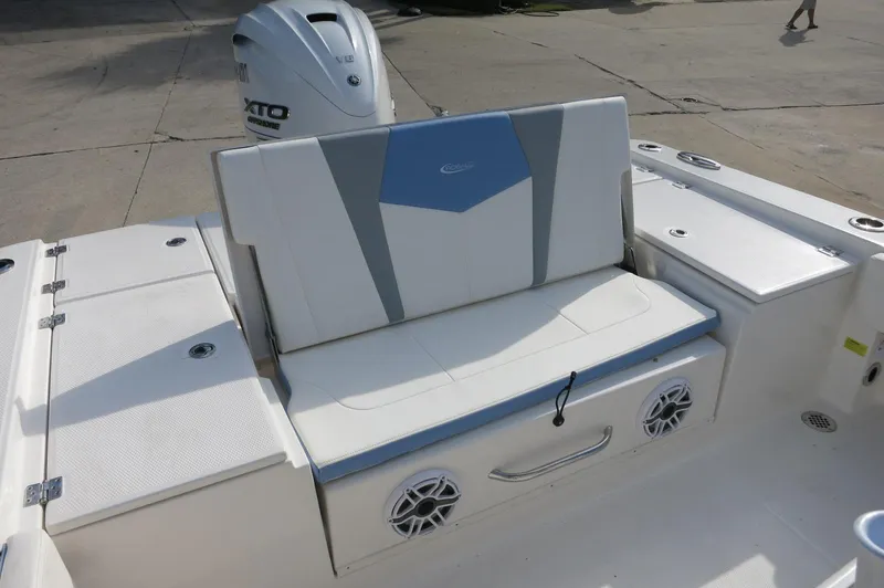 Slide: The Image of 2024 Robalo R266 Skydeck boat with cushioned seating and Yamaha outboard motor. - 17