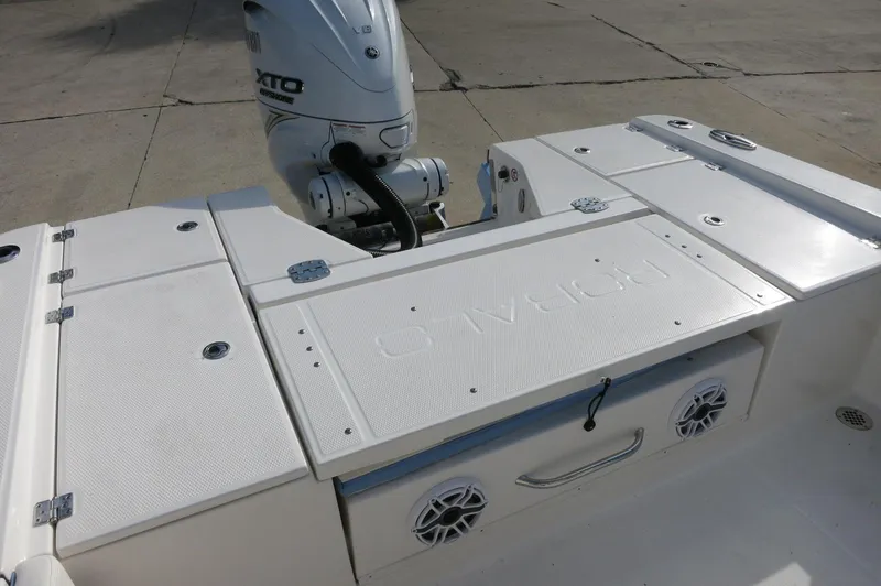 Slide: The Image of 2024 Robalo R266 Skydeck boat stern with Yamaha outboard motor and storage compartments. - 18